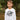 Child wearing a white long-sleeve shirt with 'Best Brother Ever' text outdoors.