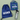Blue drawstring bag, lunch bag with dinosaur patterns, and water bottle with 'GEORGE' on a light green background