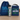 Blue drawstring bag, clear water bottle with dinosaur design, and blue lunch bag with 'ARCHER' on a wooden surface.