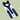 A navy blue bow tie and matching suspenders set on a white display card, photographed against a solid pale green background.