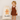 Child in a brown dress standing next to a personalized gingerbread man bag with 'Annabelle' on a plain background
