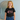 Girl wearing black tee with pink art deco print on it