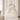 Ivory lace and tulle flower girl dress hanging on door