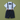 A baby boy's formal outfit set featuring a light blue short-sleeve button-down shirt with a tiny anchor pattern, dark navy suspenders with tan leather accents, a matching navy bow tie, and navy shorts, laid flat on an olive green background.