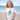 Child wearing a white t-shirt with a mermaid design on a beach