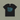 Black t-shirt with blue 'Mermaid at Heart' design on a beige background
