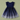 A navy blue girls' dress with a solid navy bodice, ruffled cap sleeves, and a flared tulle skirt decorated with small white star prints, laid flat on a sage green background.