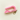 Pink plastic clip with a keychain on a white textured background that releases child car seat buckle