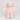 A soft plush bunny toy in a pale blush pink color, featuring long floppy ears with white inner linings, small black bead eyes, and a tiny pink stitched nose, photographed against a seamless light gray background.