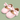 A pair of baby girl's Mary Jane shoes in light pink, featuring satin bows on the toes and a hook-and-loop strap closure, set against a solid sage green background.