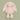 A light pink plush bunny toy with long floppy ears, white inner ears, and small embroidered facial features, centered on a solid sage green background.