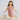 Young girl in a pink fringe dress holding a silver handbag on a beach.