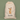 A cream-colored canvas Christmas stocking bag with a drawstring closure, featuring a cartoon reindeer graphic and the personalized name 'Annabelle' printed in black script on the front, set against a solid sage green background.