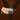 Hand fastening a seatbelt on a brown background